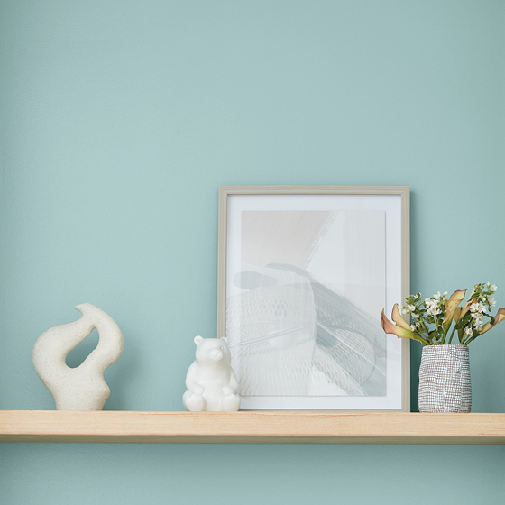 Light wooden shelf holds accessories chosen to express personal style.