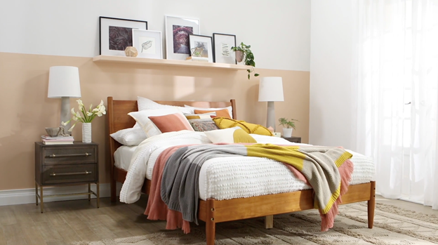 Bedroom with shelf at mid-height. Wall below shelf is a tan neutral and above shelf is white. 